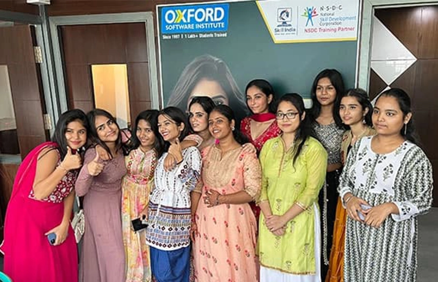 Group of female students celebrating in traditional attire at Oxford Software Institute