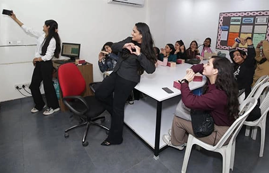 Students taking selfie and enjoying group activities in Oxford Software Institute classroom